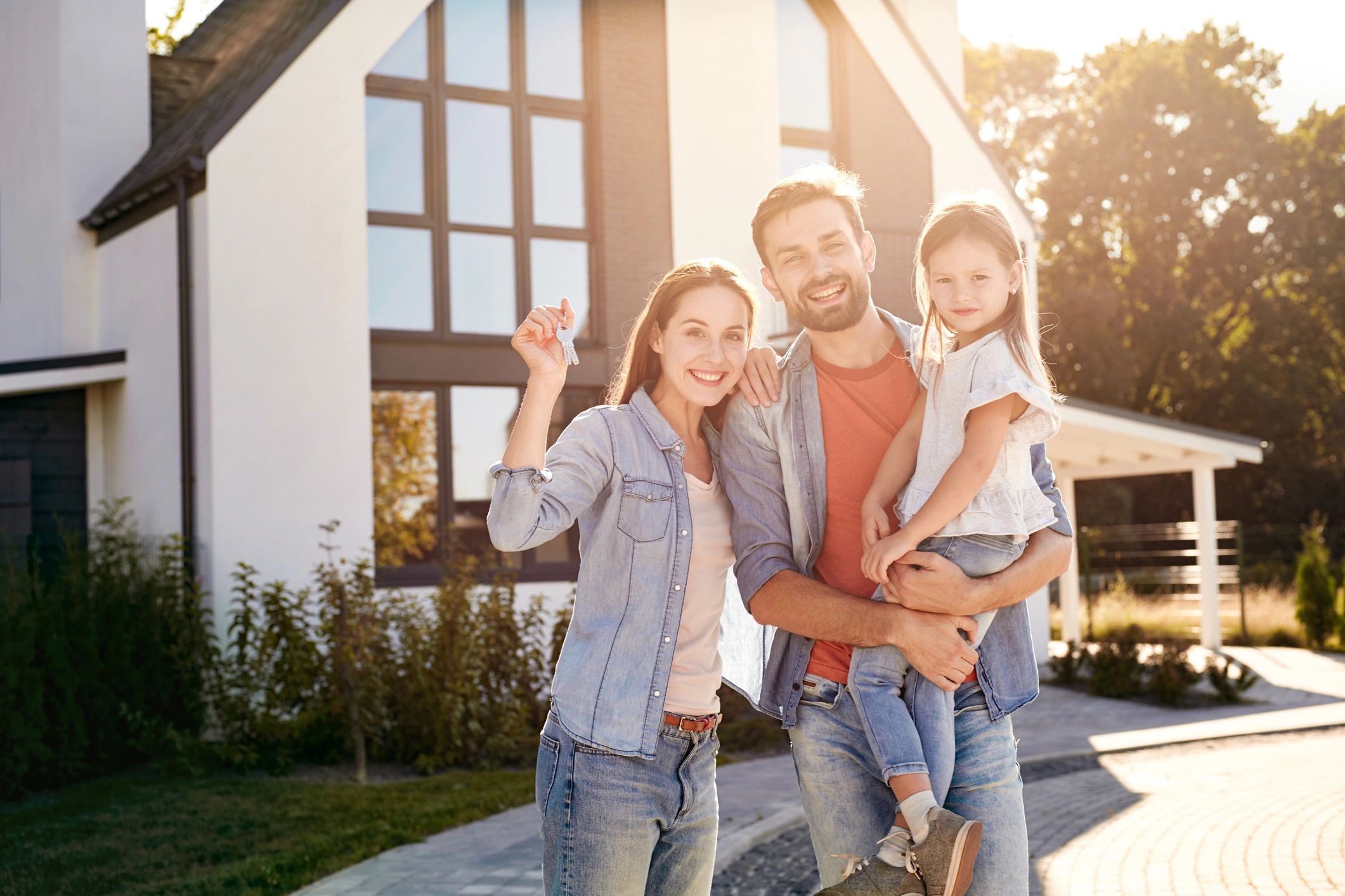Happy family outside their new home