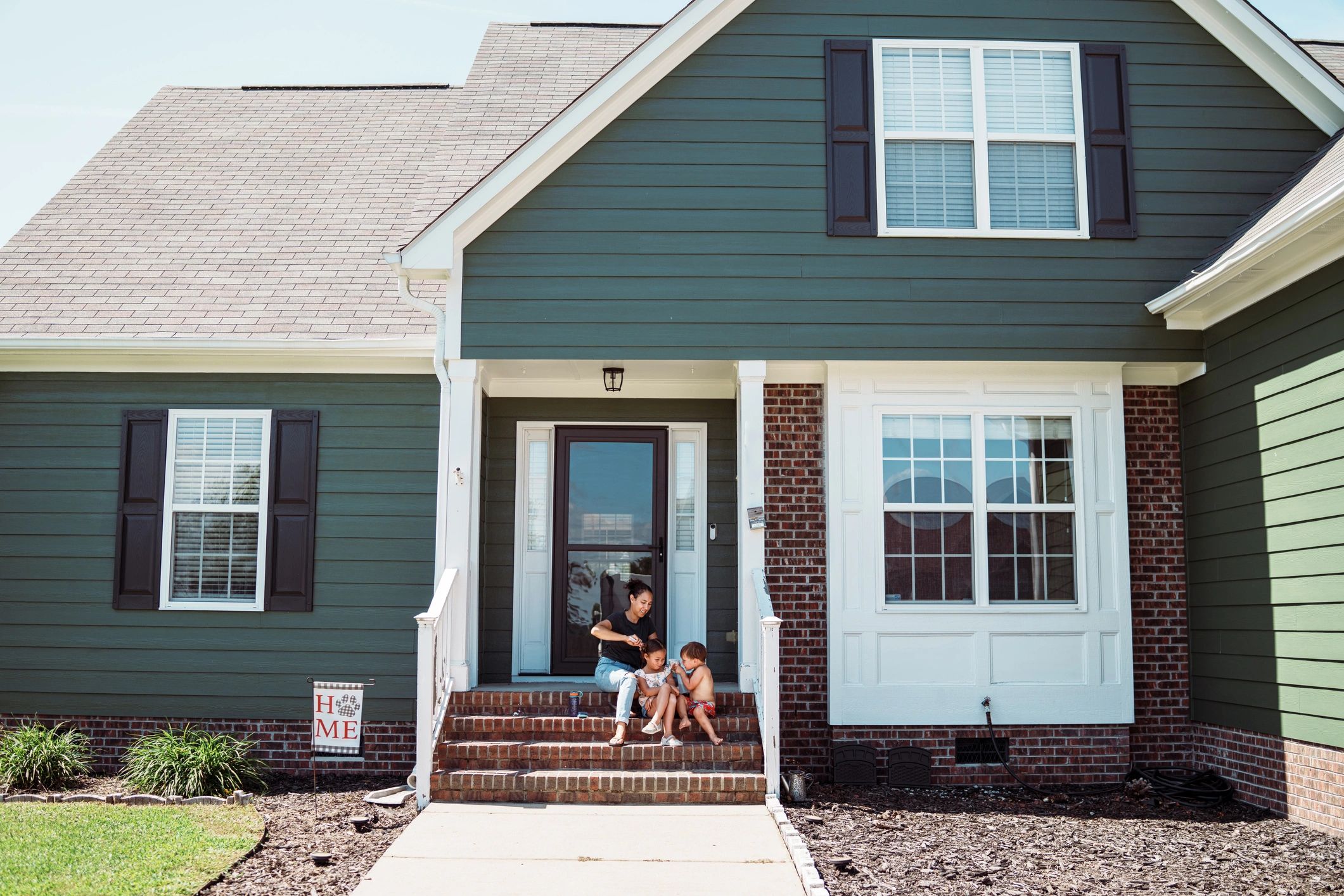 Mom Styling Daughter's Hair Outside at Home